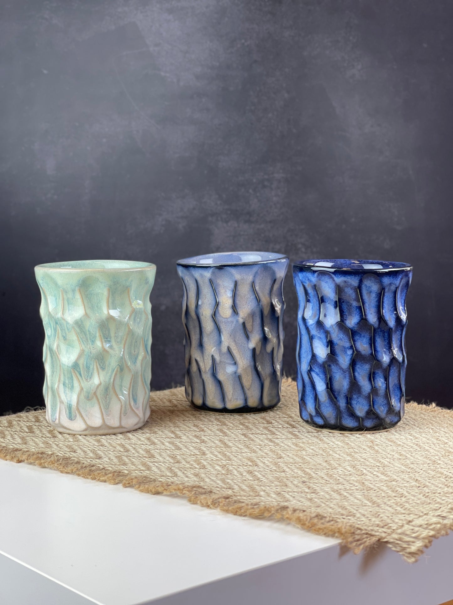 Three ceramic cups of different colors