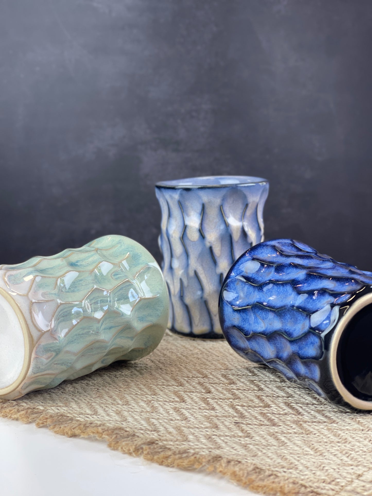 Three ceramic cups of different colors