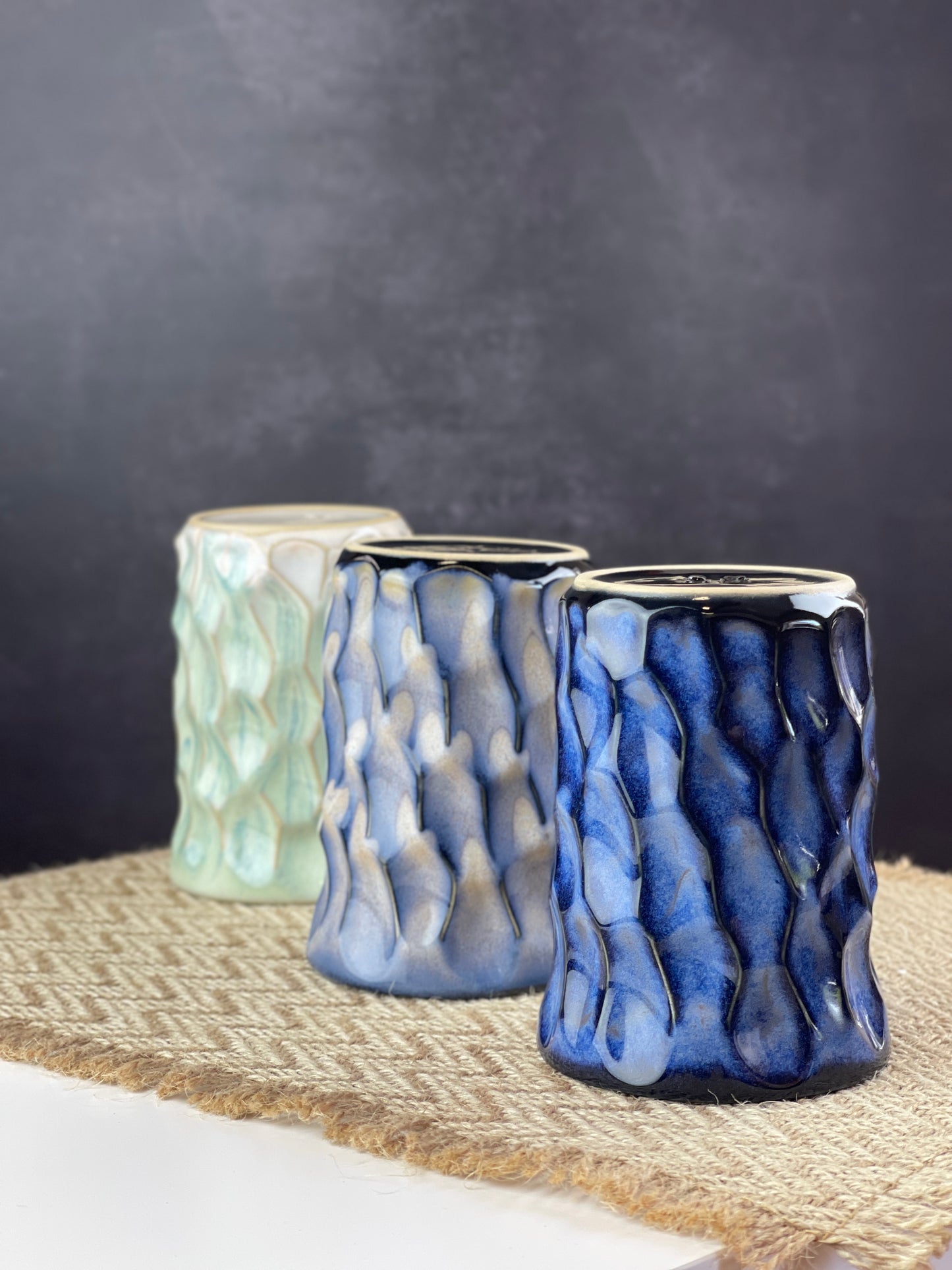 Three ceramic cups of different colors