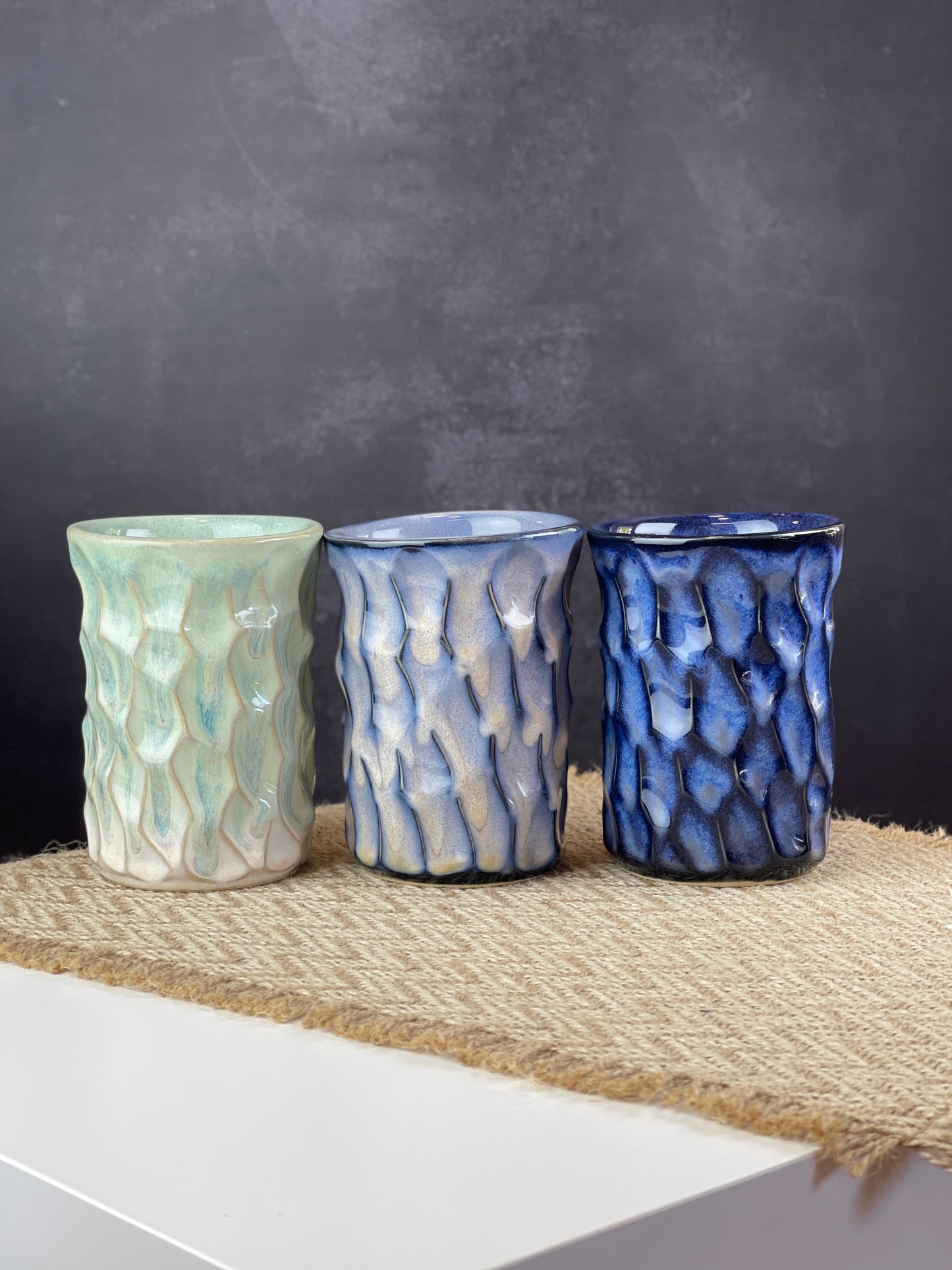 Three ceramic cups of different colors