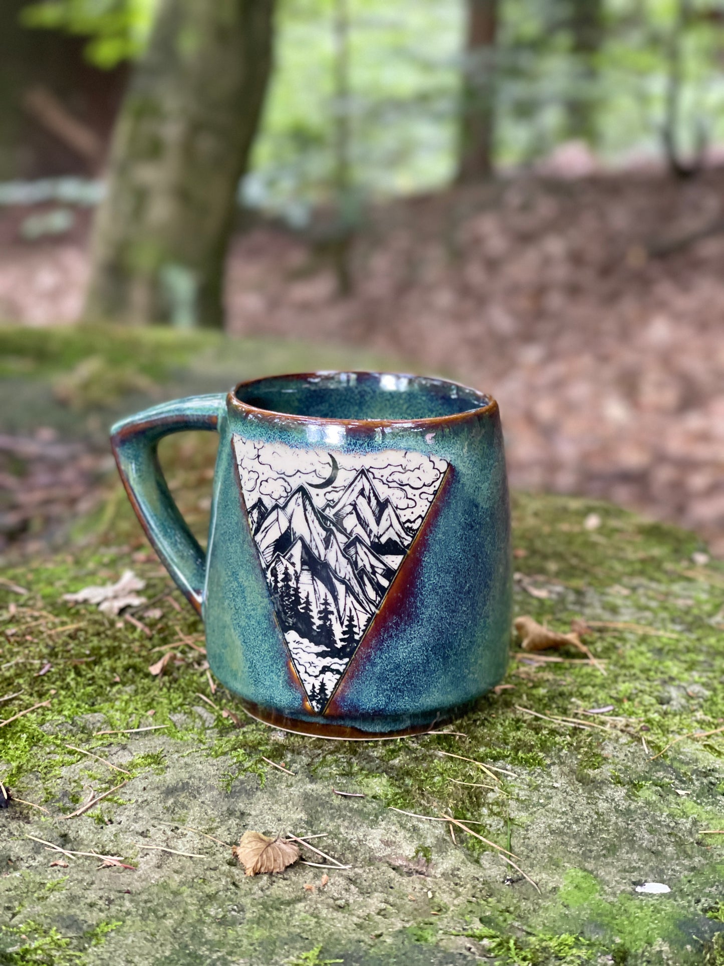 Green mug with mountains