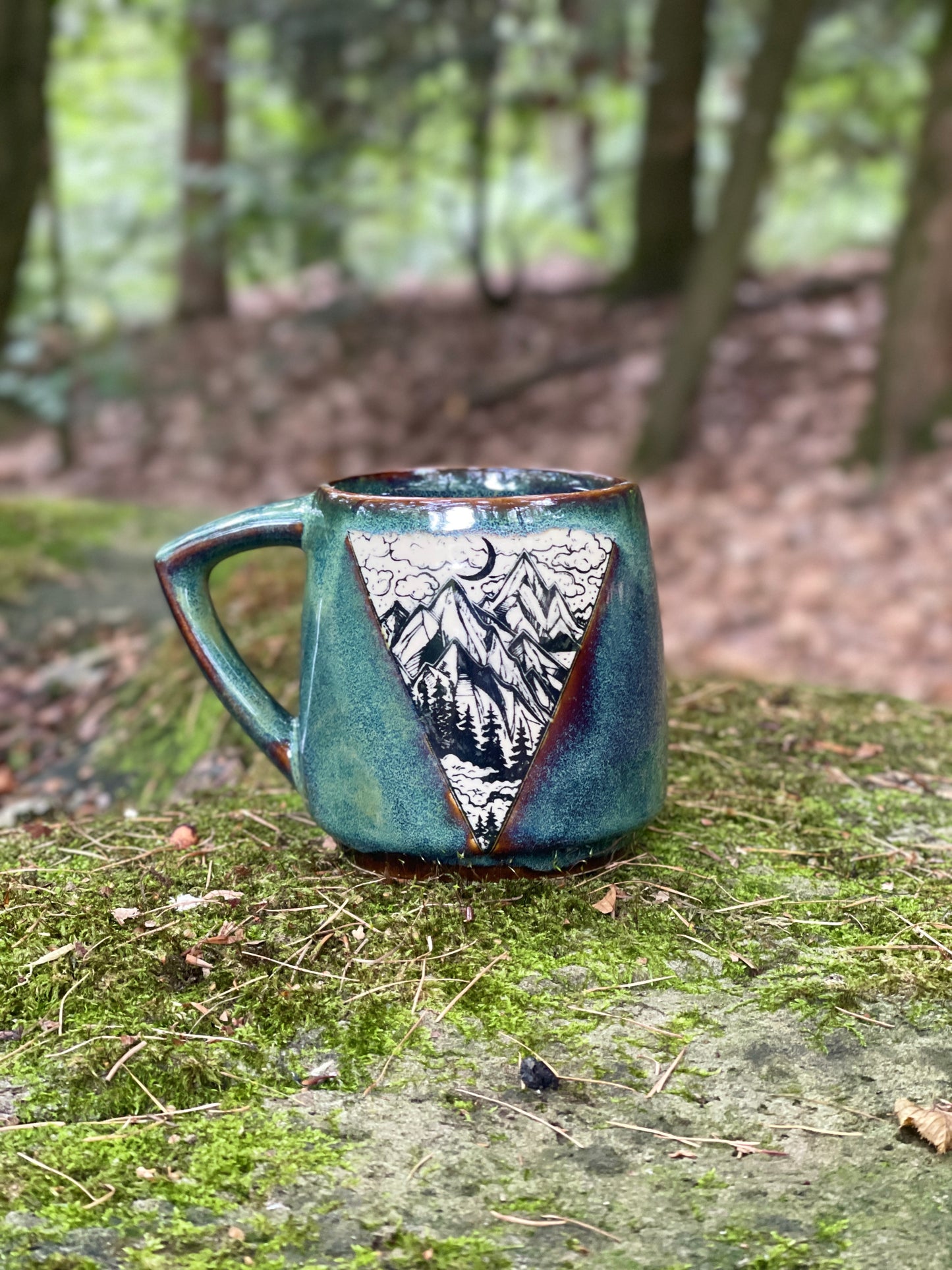 Green mug with mountains