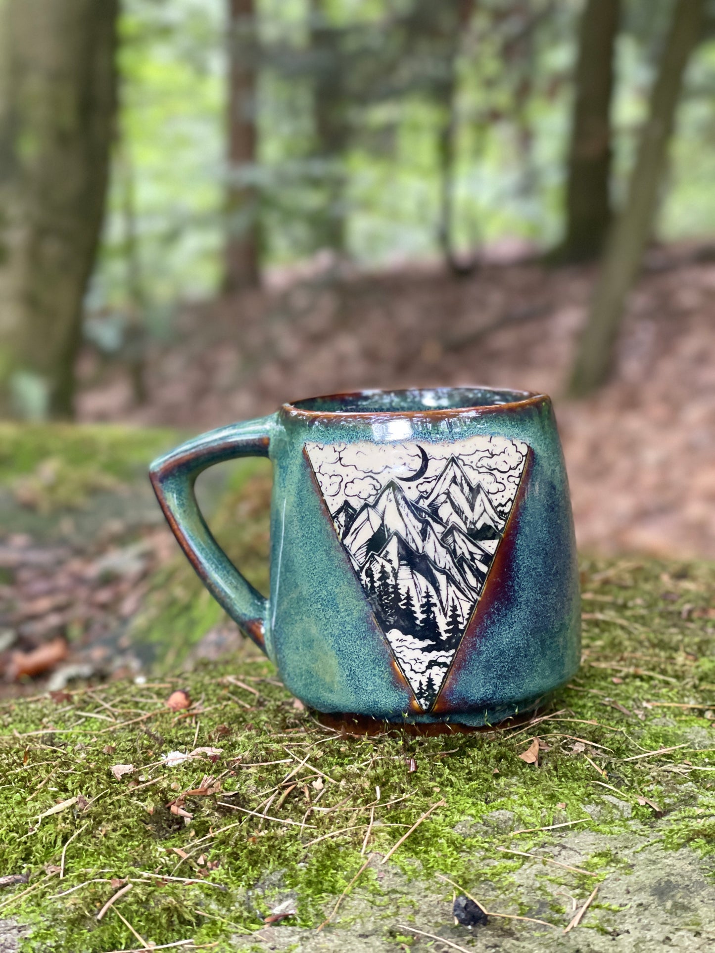 Green mug with mountains