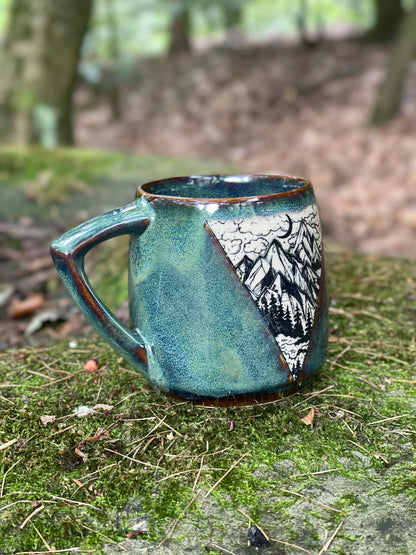 Green mug with mountains