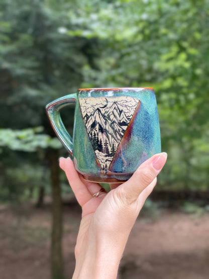 Green mug with mountains